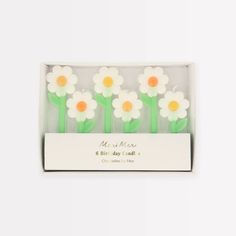 four small white and orange flowers in a box with the words mr & mrs on it