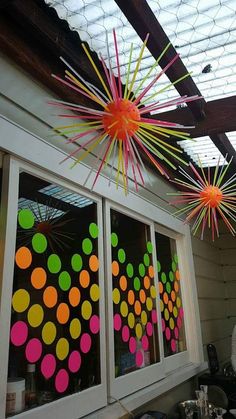 colorful paper fireworks are hanging from the ceiling