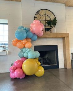 a bunch of balloons that are in front of a fireplace