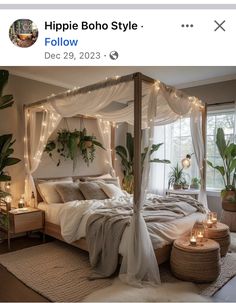 a bed with white sheets and lights in a room next to a window, potted plants on the floor