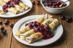 cranberry sauce is on top of the crepes and it's ready to be eaten