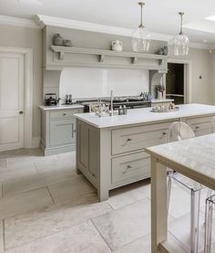 a large kitchen with an island in the middle and lots of counter space around it