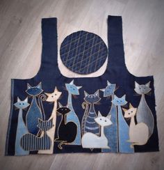 an apron made out of denim with cats on it