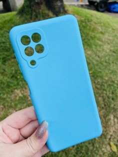 a person holding up a blue cell phone in their left hand and the case is slightly open