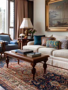 a living room filled with furniture and a painting on the wall