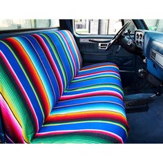 the interior of a car with multi - colored seat covers