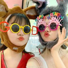 two women wearing animal ears and sunglasses