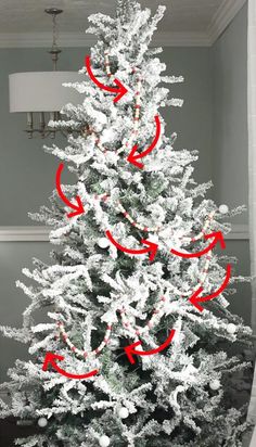 a white christmas tree with red arrows pointing in the direction of different directions on it