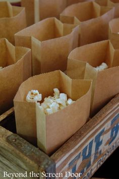 some brown paper bags filled with popcorn