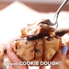 there is a person holding a spoon with some food on it and the words are pure cookie dough