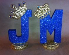 the letters are made out of glitter and have crowns on top of each letter's head