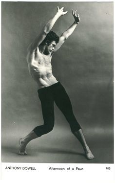 an old black and white photo of a shirtless man in tights, dancing