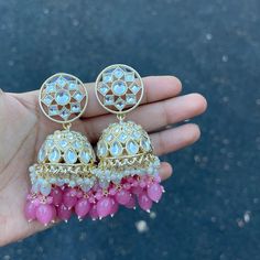 Our Pink Navi Jhumka Earrings are the perfect Jhumkas. These beauties are handcrafted to perfection with a high quality Kundan with hydro beads, and pearls on Gold Plating. Specifications Materials used: Kundan, Pearls, hydro beads, Gold Plating Weight: 35 g Height: 3 inches At Romikas, we pride ourselves on the craftsmanship and high quality of our jewelry, designed to enhance your natural beauty. Please contact us with any questions. Cheap Jhumkas For Navratri, Cheap Festive Jhumkas With Latkans, White Beaded Temple Jewelry Earrings, Temple Jewelry Chandbali Beaded Earrings, Latkan Round Bead Earrings For Weddings, Festive Bollywood Style Earrings With Round Beads, Festival Chandbali Bridal Earrings With Beads, Bollywood Style Round Bead Earrings For Festive Occasions, Traditional Festive Beaded Earrings With Pearl Drop