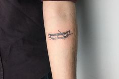 a person with a tattoo on their arm is holding a knife in one hand and an arrow in the other