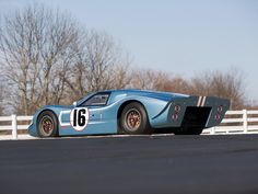 an old race car is parked on the street