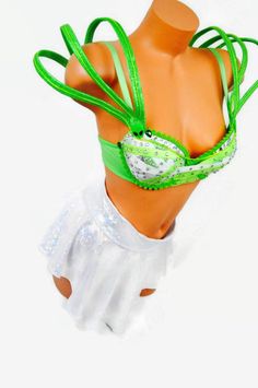 a female mannequin wearing a green bra and white skirt with ribbons around it