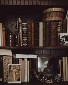 an old book shelf with books and other items on it, including a leather hat