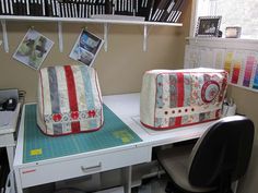 two quilted bags sitting on top of a desk