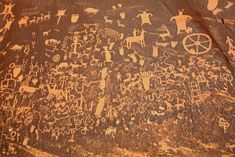 an ancient rock painting depicting people and animals