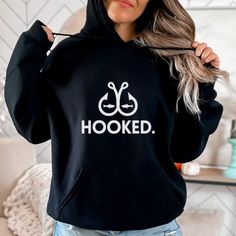 Hooked Fishing Hoodie | Fisherman Hoodie Available In Unisex Xs, S, M, L, Xl, And Xxl. Just Place An Order And Message Your Size After! Celebrate Your Passion For Fishing With Our ""Hooked"" Hoodie! Made From Soft, Durable Fabric, This Hoodie Is Perfect For Long Days On The Water Or Casual Outings. It Features A Spacious Front Kangaroo Pocket, Adjustable Drawstring Hood, And Ribbed Cuffs For A Cozy Fit. A Fantastic Gift For Fishermen And Anglers, This Hoodie Is A Must-Have For Anyone Who Loves T Fishing Hoodie, Fishing Sweatshirts, Fisherman Gifts, Fishing Gifts, Camping Gifts, Cozy Fits, Great Outdoors, Fantastic Gifts, The Great Outdoors