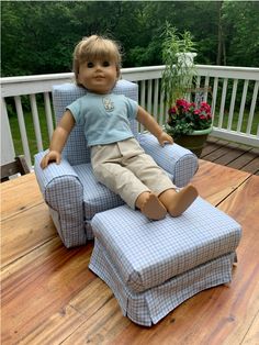 a doll sitting on top of a blue chair