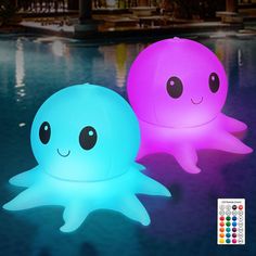 two colorful lights sitting next to each other on top of a blue and pink pool