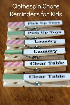 clothespin chores reminders for kids are lined up on a wooden table with clips