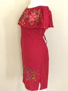 "Mexican Off the shoulder tie back dress. With beautiful hand embroidery.Made out of manta, 100% cotton. Color: Red/ Multicolored embroidery. Size- Medium Dimensions: Bust- 43\" Hips- 43\" Waist- 43\" Length- 31\" 🧵Made in Chiapas, Mexico. 🧺Care Instructions: We recommend hand washing, lay flat to dry. 📲Please feel free to message me with any questions regarding sizing and fit. 📷Additional photos can be provided upon request. 👗Always allow a little room and consider your own measurements be Traditional Summer Peasant Dress With Floral Embroidery, Traditional Peasant Dress With Floral Embroidery For Summer, Peasant Style Red Embroidered Dresses, Embroidered Summer Peasant Dress, Peasant Embroidered Vacation Dresses, Embroidered Peasant Dress For Summer, Summer Embroidered Dress With Yoke, Summer Embroidered Dress With Yoke Detail, Bohemian Embroidered Off-shoulder Summer Dress