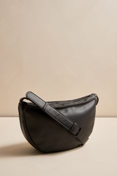 Introducing our brand new half-moon vegan leather handbag. This modern and stylish bag is the perfect accessory to any fall look. Our team loves it and we're sure you will too!Made from vegan leatherCruelty free and easy to care forTop zipper to keep your belongings safeWomance logo embossed on the frontStrap adjustable up to 39"Can be worn as a shoulder or cross-body bagTwo inside pockets (one with zipper)Dimensions: 12.5" (width) x 7.25" (height) x 3" (depth)Exterior: vegan leather, 100% PolyurethaneInterior lining: 100% polyester



Care Instructions: Hand wash with a clean damp cloth. Versatile Everyday Faux Leather Baguette Bag, Trendy Hobo Bag With Round Handle For Everyday, Versatile Faux Leather Baguette Bag With Removable Pouch, Trendy Bag With Round Handle For Everyday Use, Trendy Soft Leather Baguette Bag For On-the-go, Versatile Faux Leather Hobo Bag Crossbody, Versatile Faux Leather Crossbody Hobo Bag, Trendy Leather Saddle Bag With Double Handle, Trendy Leather Saddle Bag For On-the-go