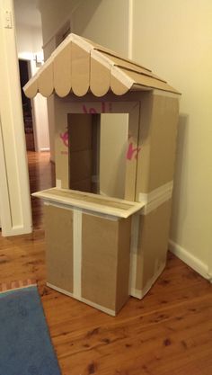 a cardboard doll house is sitting on the floor