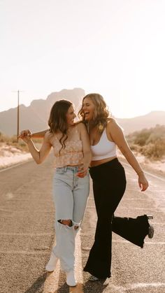 two women are walking down the road together