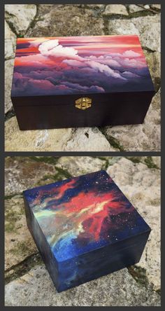 two boxes that are sitting on the ground, one with an image of clouds and stars painted on it