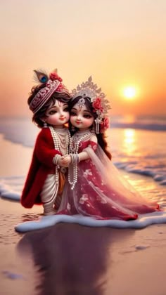 two dolls are hugging on the beach at sunset