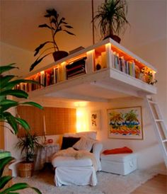 a loft bed with stairs leading up to the upper level and bookshelves above it