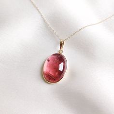 This stunning pendant is set in 14k Solid Yellow Gold with Natural Rubellite Pink Tourmaline with utmost precision. It is an unique gemstone pendant for nearly every occasion and is completely hassle-free jewelry. ITEM DETAILS * Gem: Rubellite Pink Tourmaline * Gem Size: 16X21mm * Gem Shape: Oval Cab * Gem Weight: 22.36 carats * Gold Purity: 14KT  * Gold Weight: 0.838 gram * Total Weight of the Pendant: 5.310 gram ✔️The Gold purity is guaranteed and it comes with authentic 14KT gold hallmark. Si Body Accessories, Handmade Jewelry Box, Tourmaline Pendant, Earrings Design, Tourmaline Jewelry, Jewelry Christmas, Birthstone Pendant, October Birthstone, Unique Gemstones