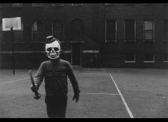 a skeleton tennis player wearing a mask and holding a racquet in his hand