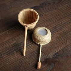 two wooden spoons sitting next to each other on top of a wooden table,