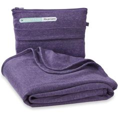 the purple blanket is folded up and ready to be used as a travel pillow or seat cushion