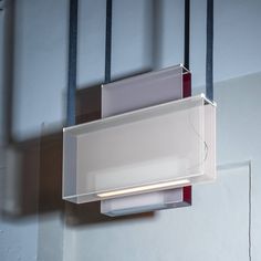 a light that is on the side of a wall with wires attached to it's sides