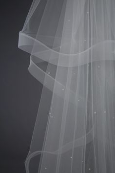 the back of a white veil on a black background