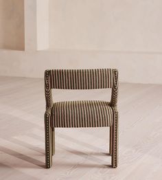 a striped chair sitting on top of a hard wood floor