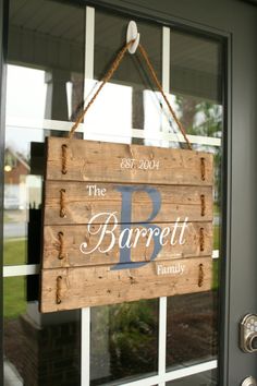 a wooden sign hanging from the side of a door that says the barpeti family