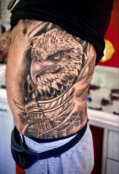 a man with an eagle tattoo on his stomach