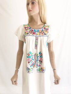 Beautiful vintage 70's Mexican embroidered dress. Raw cotton fabric. Hand embroidered. Vibrant colors. Hard to find, shorter length. In great vintage condition Size. Fits small to x small approx Spring Embroidered Dress With Multicolor Machine Embroidery, Vintage Dresses With Multicolor Embroidery For Spring, Retro Embroidered Cotton Dress, Retro Embroidered Summer Dress, Summer Retro Embroidered Dress, Vintage Cotton Dress With Floral Embroidery, Vintage Cotton Embroidered Dress With Floral Embroidery, Short Sleeve Cotton Dresses With Embroidered Border, Cotton Short Sleeve Dress With Embroidered Border