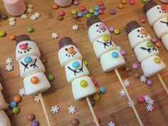 some marshmallows are decorated with snowmen and candy