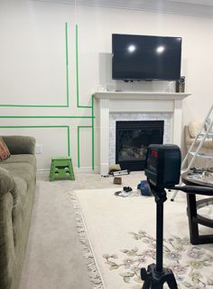 a living room with a fire place, couch and television on top of a stand