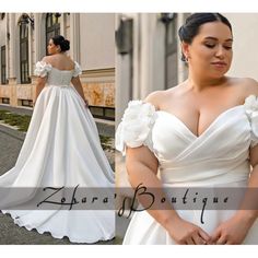 a woman in a white wedding dress with flowers on the shoulders and shoulder, standing next to a building