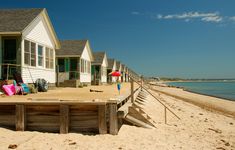 a row of beach houses next to the ocean