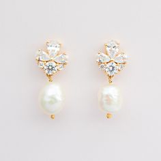 GISELLE Mini // Gold bridal pearl drop earrings - A smaller version of our best selling Giselle earrings. An elegant pair of gold cubic zirconia earrings with clear cz crystals and freshwater pearls on a gold plated finish. 14k gold plated 925 sterling silver. Due to their natural form, pearls will vary in size and shape.  Total length approx 2.3cms Pearl approx 1cms Please note, that for hygiene reasons earrings cannot be returned. Dainty Bridal Pearl Drop Earrings, Minimalist Drop Earrings For Wedding, Dainty Drop Bridal Earrings For Wedding, Delicate Cubic Zirconia Bridal Earrings With Pearl Drop, Dainty Drop Bridal Earrings, Dainty Cubic Zirconia Cluster Earrings For Wedding, Pearl Drop Cluster Earrings For Anniversary, Anniversary Pearl Drop Cluster Earrings, Delicate Pear-shaped Bridal Earrings For Anniversary