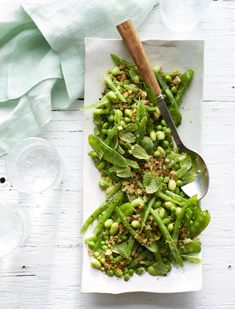 a white plate topped with green beans and sprouts